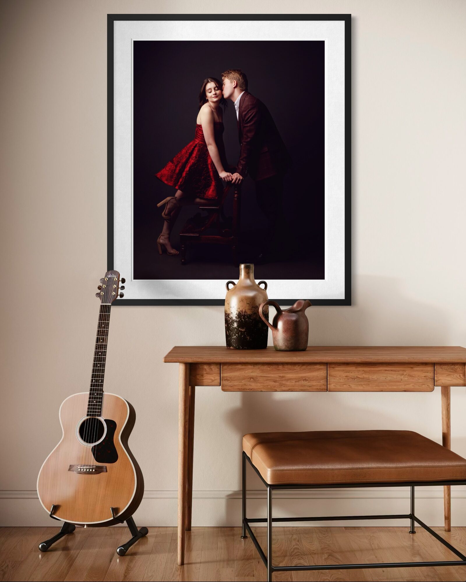 A large framed couples portrait hanging above a timber console table