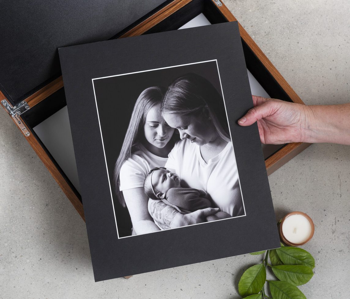 Hand-matted eight by ten portrait print held in two hands
