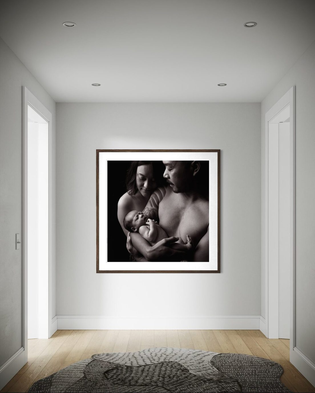 Black and white framed family portrait in a hallway
