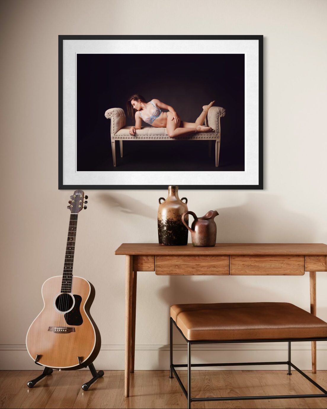 Framed Allure boudoir portrait hanging above a timber console table